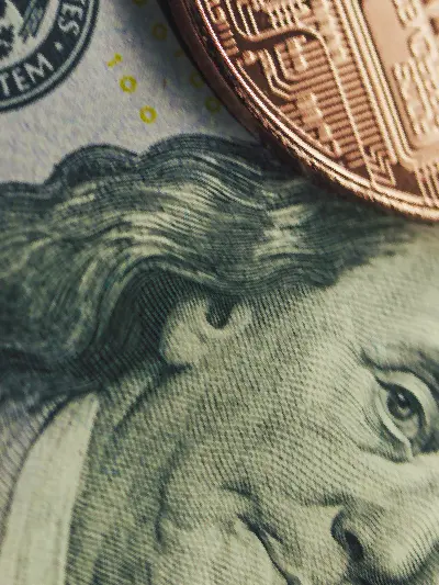 Close-up of U.S. currency with digital asset tokens, illustrating themes of tokenization and modern financial infrastructure