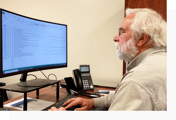 Mark Mason sits at his office desk as he works on his computer.