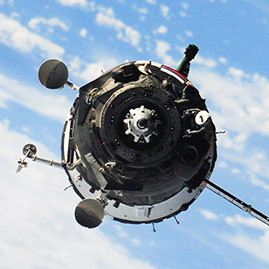 An exterior shot of a satellite that is orbiting Earth on a clear day