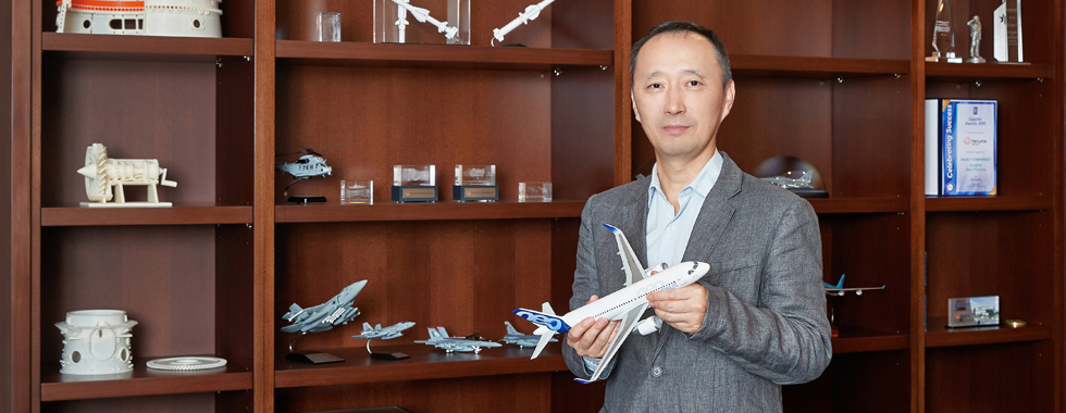 Jun Ji holds a model A320neo, one of the many types of aircraft that use engines and components assembled and manufactured by Hanwha Aerospace