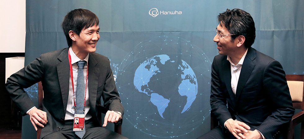Hanwha Life CIO Dong Won Kim speaks with Takashi Okita, CEO of SBI Ripple Asia, during the Hanwha Night networking event at the Boao Forum for Asia Annual Conference in Hainan Province, China