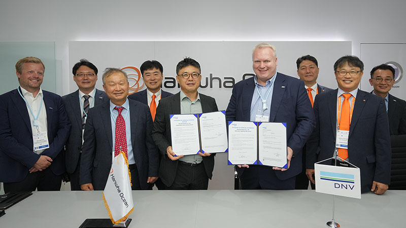 Representatives from Hanwha and DNV join for a commemorative ceremony for its shipbuilding advancements at Gastech 2023.