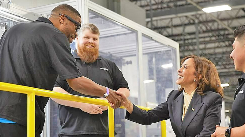 Vice President Kamala Harris shakes hands with a Hanwha Qcells employee at the Qcells Dalton Factory.