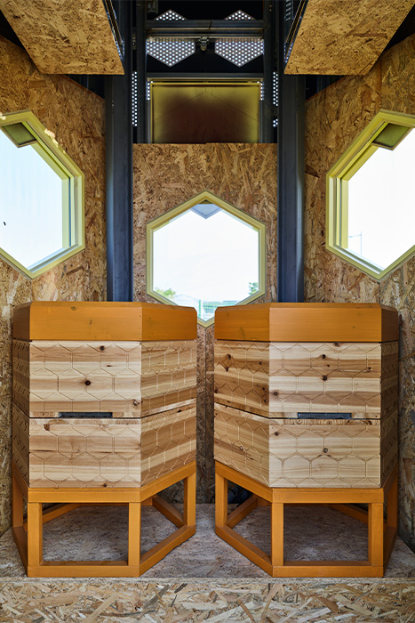 Inside the Solar Beehive are two wooden beehives that are monitored by the smart system.