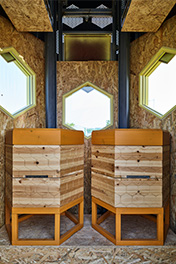 Inside the Solar Beehive are two wooden beehives that are monitored by the smart system.
