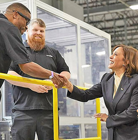 Vice President Kamala Harris shakes hands with a Hanwha Qcells employee at the Qcells Dalton Factory.