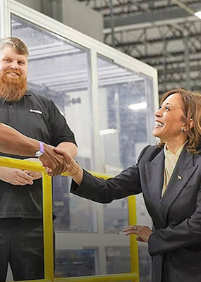 Vice President Kamala Harris shakes hands with a Hanwha Qcells employee at the Qcells Dalton Factory.