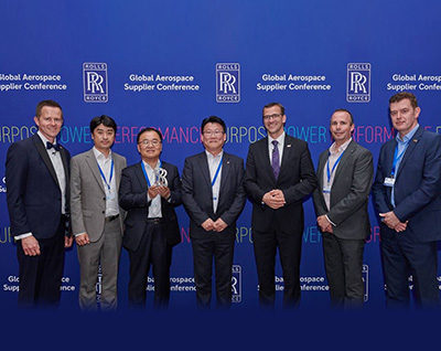 Hyung-wook Nam, head of Hanwha Aerospace’s Changwon plant, stands in a line with other executives from Rolls-Royce at the Global Aerospace Supplier Conference 2022.