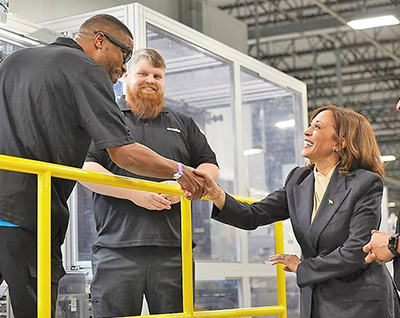 Vice President Kamala Harris shakes hands with a Hanwha Qcells employee at the Qcells Dalton Factory.