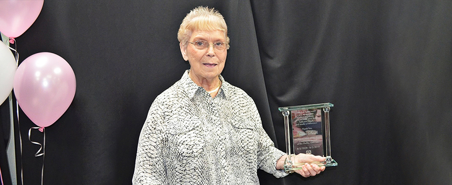 Dessie Smith displays the glass plaque she was pre