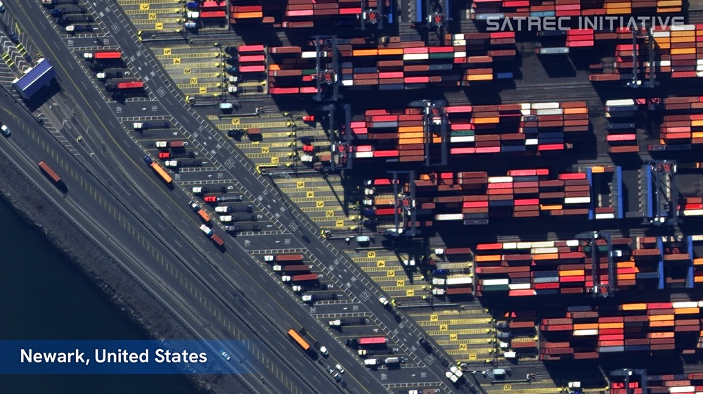 High-resolution satellite image of a busy container port in Newark, U.S., captured by SpaceEye-T showing trucks and stacked cargo 