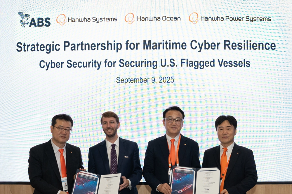 Hanwha Systems, Hanwha Ocean, Hanwha Power Systems, and ABS leaders pose in front of screen while holding signed documents