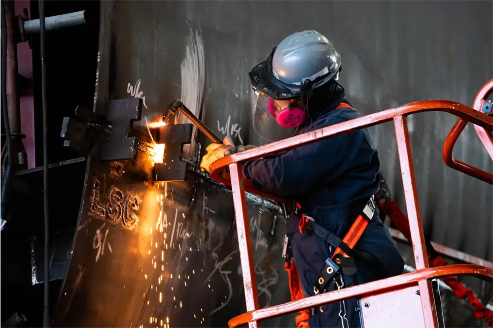 A welder works on a vessel at Hanwha Philly Shipyard
