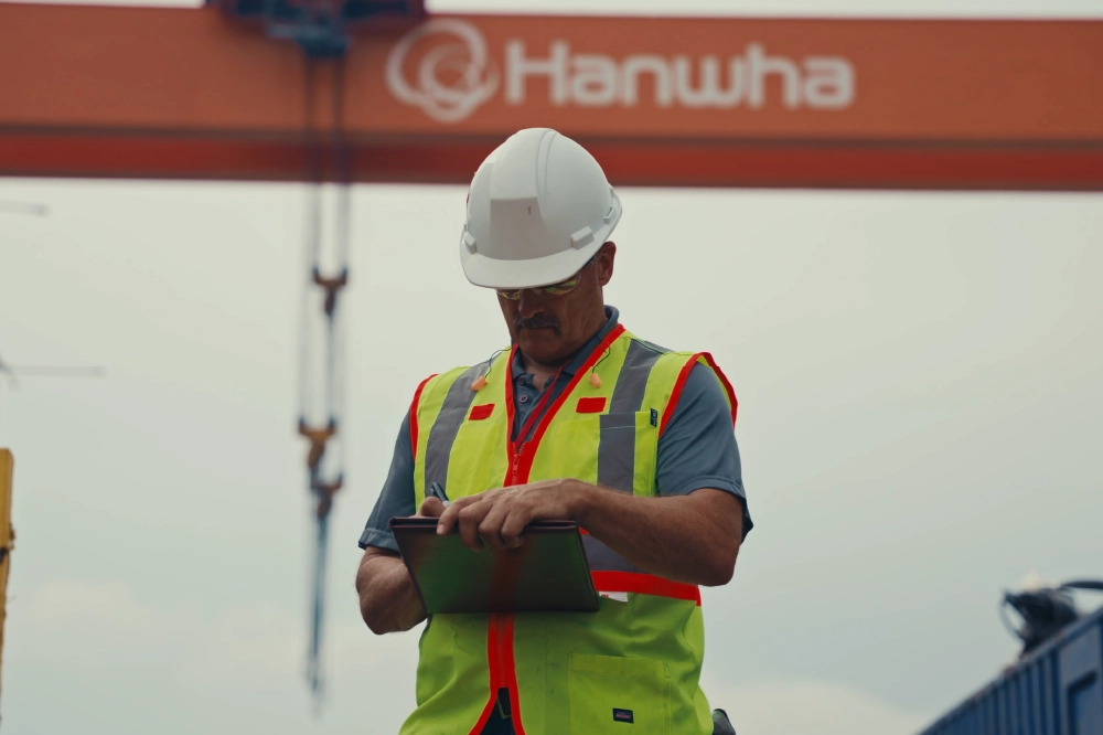 A construction worker looking at plans