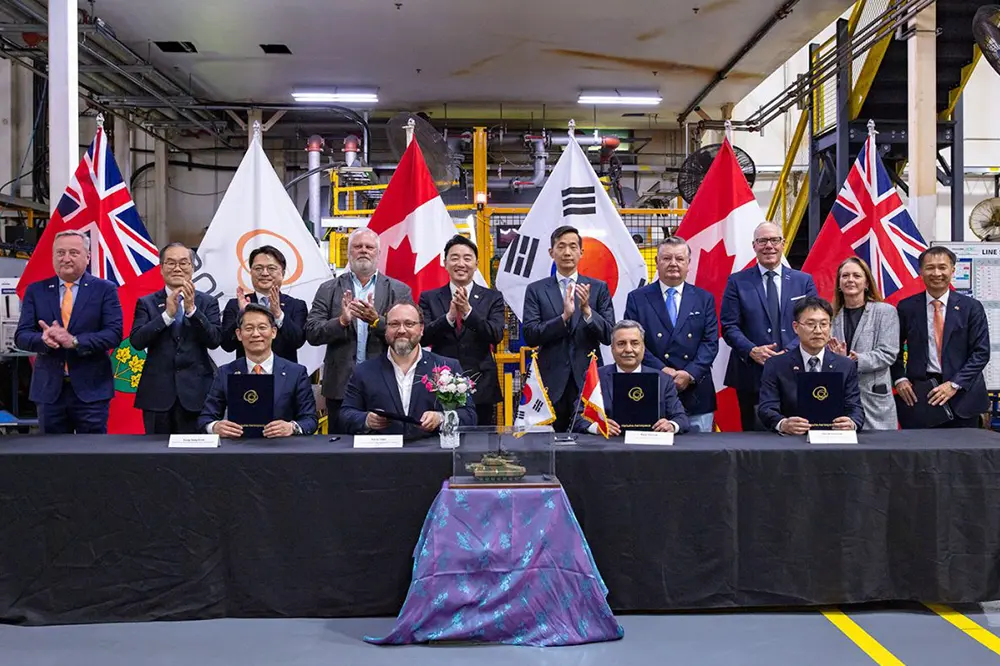 Republic of Korea officials and Canadian industry leaders display a signed Canada-Korea partnership agreement.