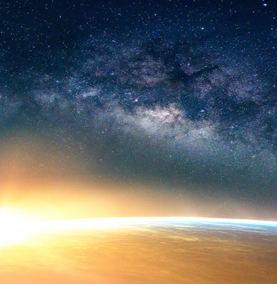 Earth illuminated by the rising sun as seen from outer space.