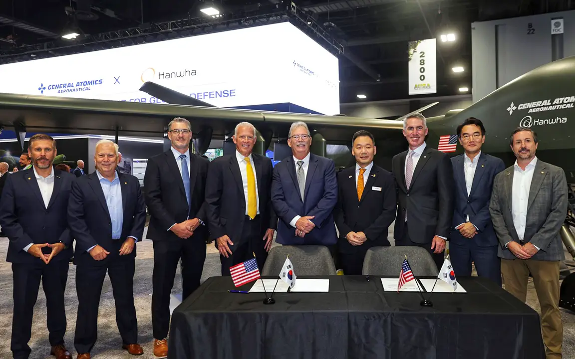Executives from Hanwha Aerospace and GA-ASI at AUSA 2025 during the UAS co-development agreement signing ceremony.