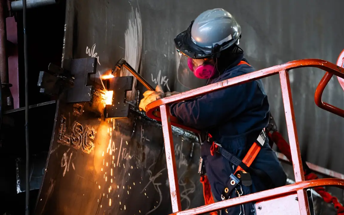 A welder works on a vessel at Hanwha Philly Shipyard